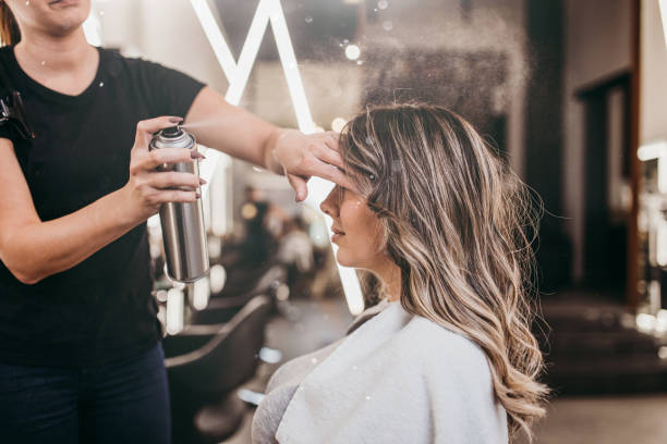 Woman at hair salon Beautiful brunette woman with long hair at the beauty salon getting a hair blowing. Hair salon styling concept. fashion week stock pictures, royalty-free photos & images