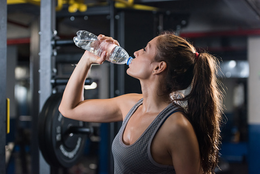 Woman At The Gym Drinking Water Stock Photo - Download Image Now - iStock