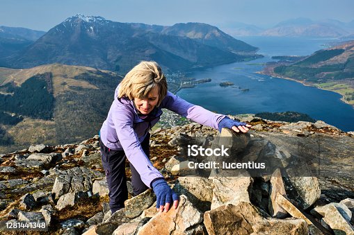istock Woman at the summit of the Pap of Glencoe, Scotland 1281441348