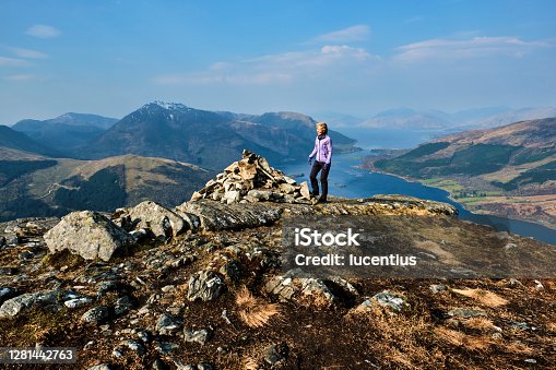 istock Woman at the summit of the Pap of Glencoe, Scotland 1281442763
