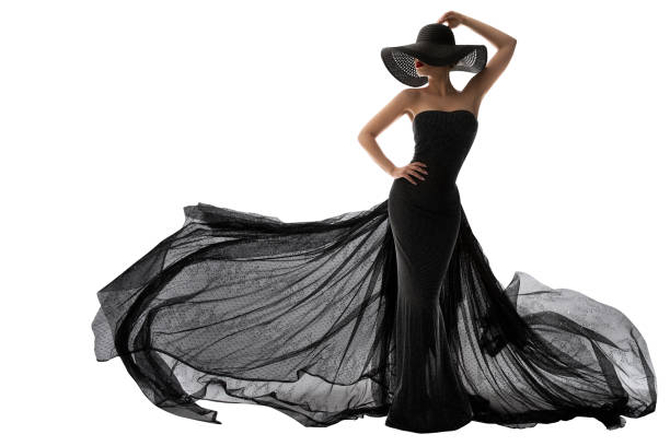 Woman Black Dress Fashion. Elegant Lady in Hat. Model Silhouette in Evening Long Black Gown Fluttering on Wind. Isolated White stock photo
