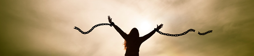 Woman breaks her chains as a symbol of freedom