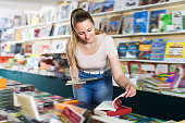 istock Woman buying books in hard cover 1320278948