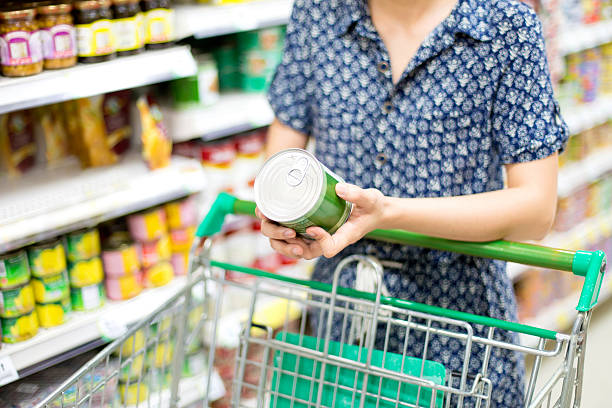 woman buys canned stock photo