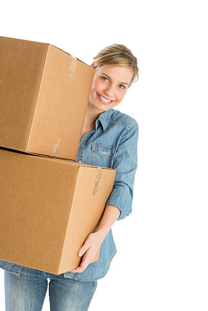 Woman Carrying Stacked Cardboard Boxes stock photo