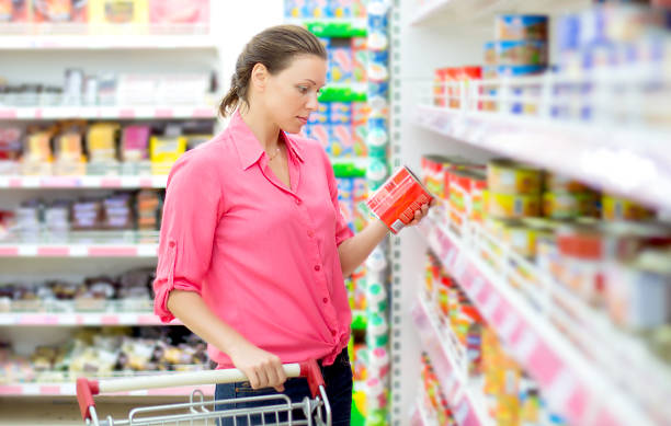Woman checking food labelling stock photo