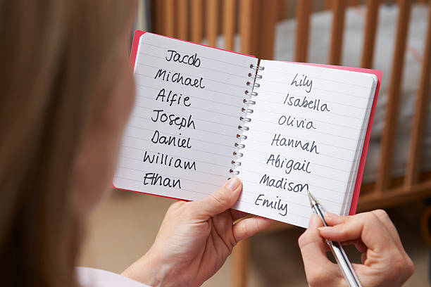 Woman Choosing Baby Names In Nursery stock photo
