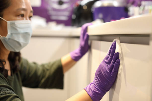 Woman cleaning kitchen locker Woman wearing purple gloves cleaning kitchen locker asian maids stock pictures, royalty-free photos & images