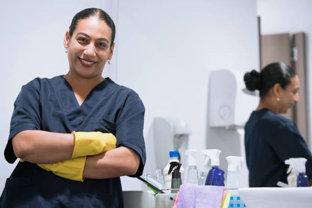 Woman cleaning the bathroom Latin woman between 35 - 45 years old is smiling cleaning the bathroom cleaner stock pictures, royalty-free photos & images