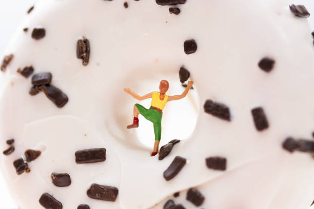 woman climbing a chocholate donut stock photo