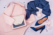 Woman clothing and accessories in pastel colors.