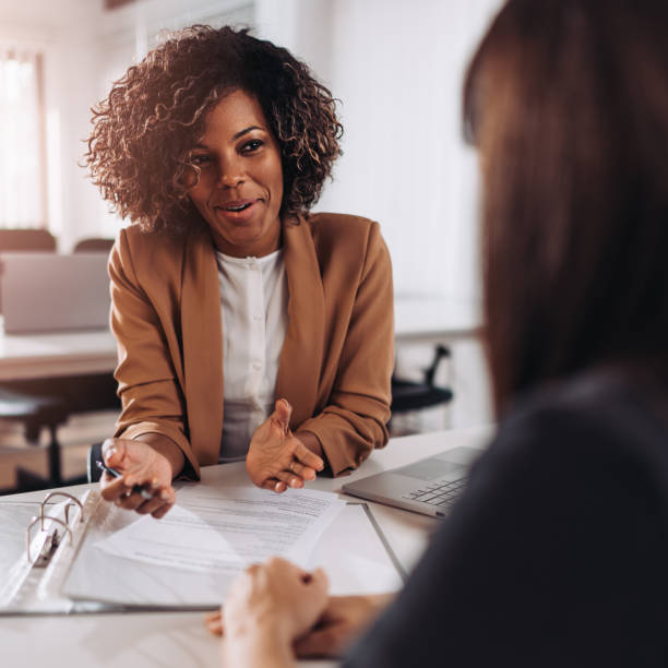 Woman consulting with a female agent stock photo