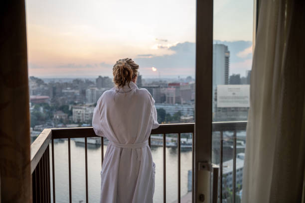 Woman contemplates Cairo city and the Nile river at sunset stock photo