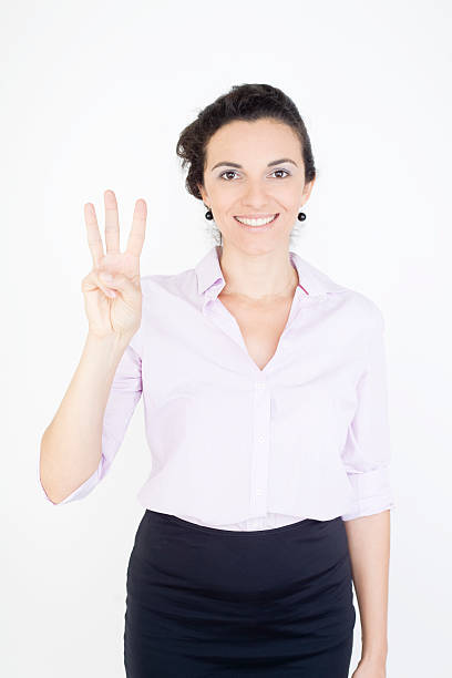 Woman counting with her fingers the number three stock photo