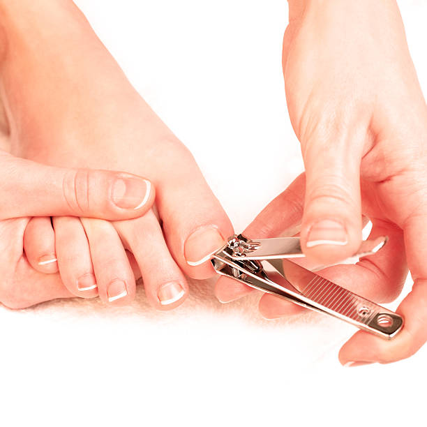 woman cutting toenails stock photo