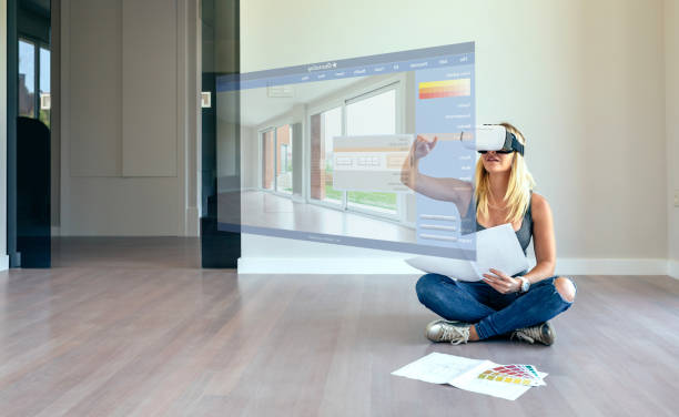 Woman decorating with virtual reality glasses stock photo