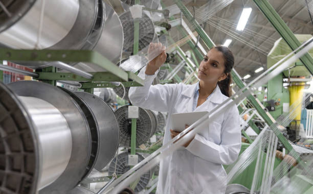 woman doing quality control at a textile factory - manufacture plastic imagens e fotografias de stock