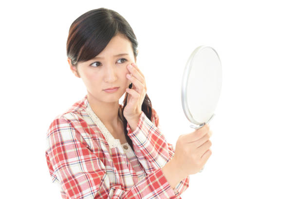 mujer haciendo cuidado de la piel con expresión preocupada - maquillaje kawaii fotografías e imágenes de stock
