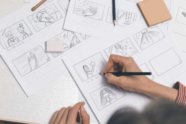 Woman draws storyboard sketches for comics or film. stock photo
