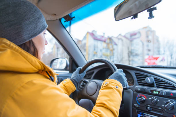 woman drive car in cold winter weather stock photo