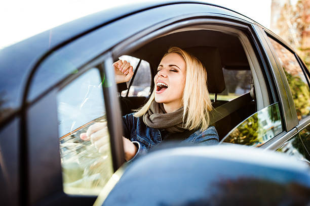 Woman driving a car Beautiful young blond woman driving a car singing stock pictures, royalty-free photos & images