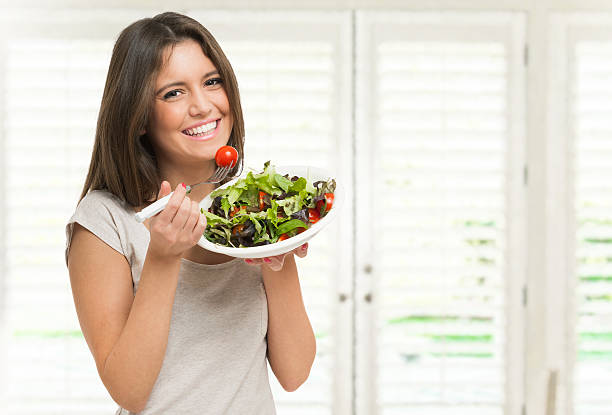 Woman eating a healthy salad stock photo