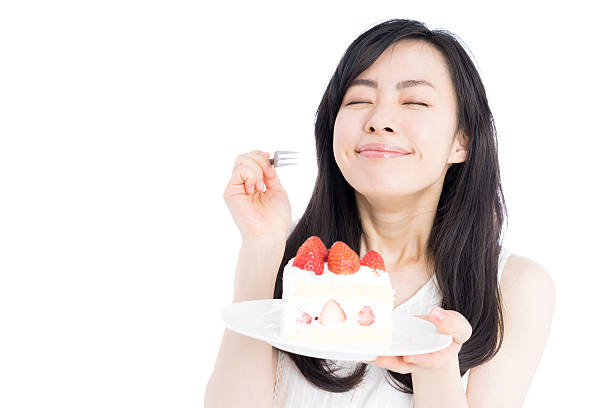 Woman eating cake stock photo