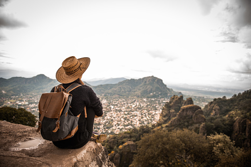 Argentinian woman traveling Mexico. She is enjoying the view on Tepoztlan, Mexico