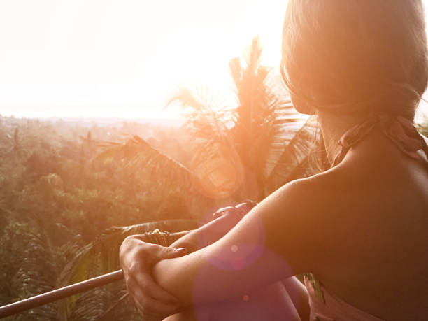Woman enjoying panoramic landscape view on a rainforest in Bali, Indonesia. stock photo