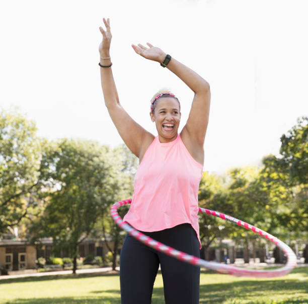 woman exercising outside in the park stock photo