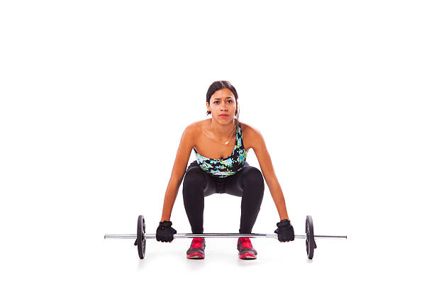 Woman exercising with a barbell weight stock photo