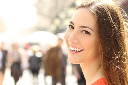 Woman face smile with perfect teeth looking you stock photo
