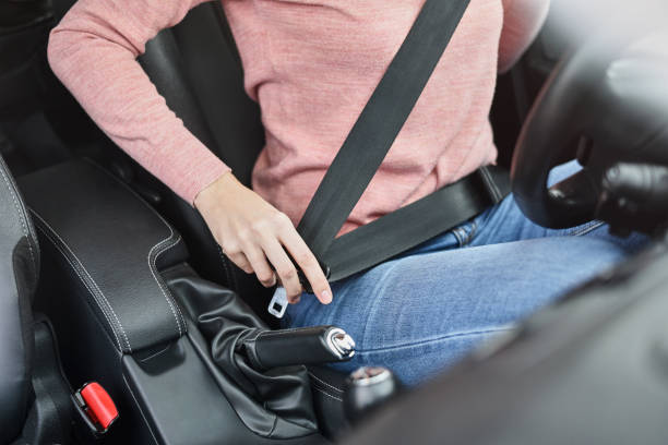 Woman fastening seat belt in the car. Car safety concept Woman fastening seat belt in car. Car safety concept seat belt stock pictures, royalty-free photos & images