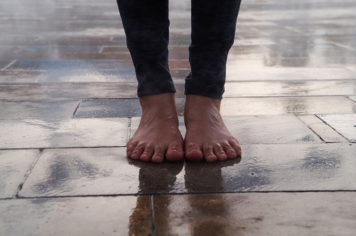 The freedom of a woman walking barefoot down the street after a little rain