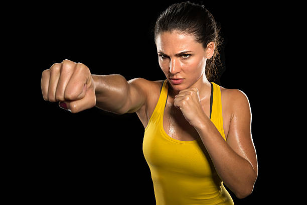MMA woman fighter tough chick boxer punch pose exercise training stock photo