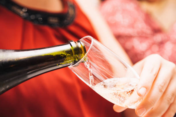 A woman filling a glass of cava stock photo