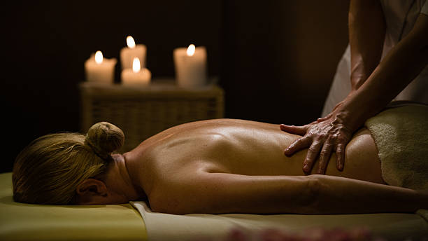 Woman Getting a Massage in a Romantic Environment stock photo
