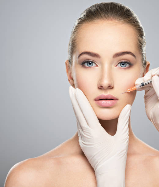 Woman getting cosmetic injection of botox near lips Woman getting cosmetic injection of botox near lips, closeup. Woman in beauty salon. plastic surgery clinic. injecting photos stock pictures, royalty-free photos & images