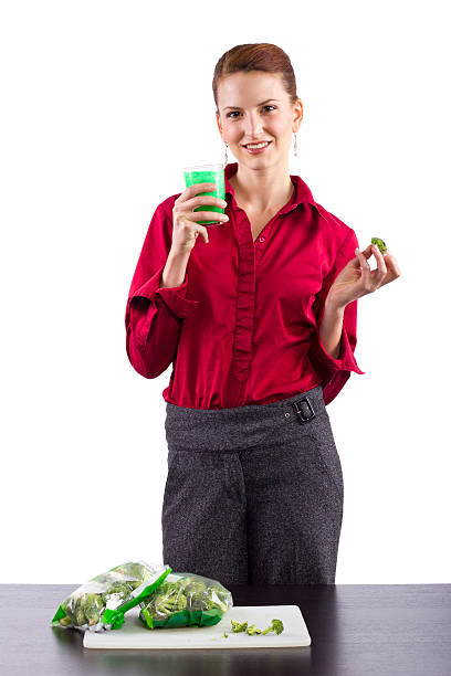 Woman grossed out by green vegetable juice woman grossed out by green vegetable juice ugly skinny women stock pictures, royalty-free photos & images