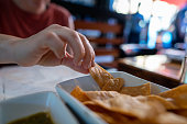 istock Woman hand grabbing gourmet tortilla at table of Mexican restaurant 1185317824