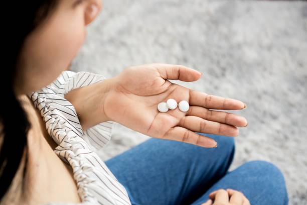 woman hand holding sleeping pills, melatonin ,overdose medicine concept stock photo