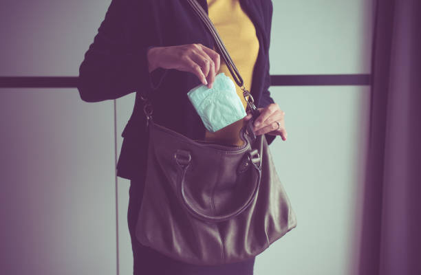 vrouw hand maandverband aanbrengend handtas, witte maandverband - tampons stockfoto's en -beelden