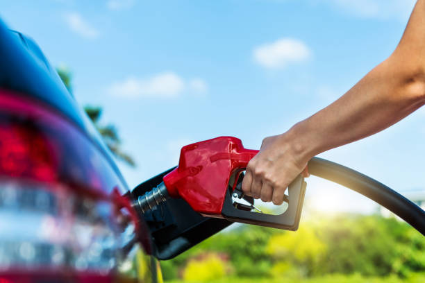 Woman hand refuelling the car stock photo