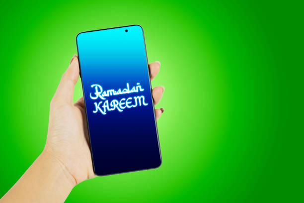 Woman hand show ramadan kareem text on cellphone stock photo