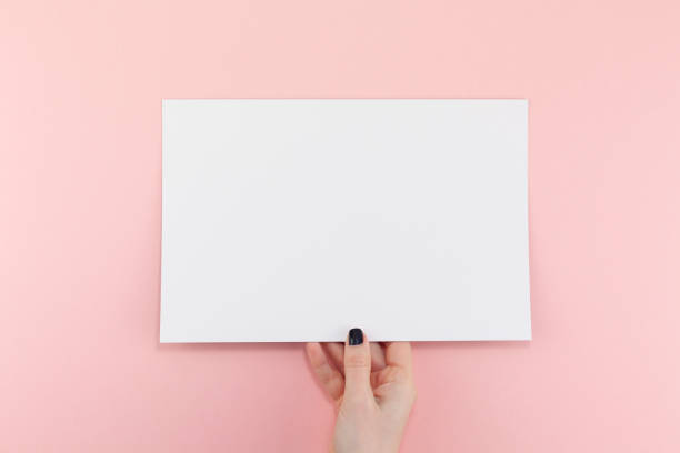Woman hands with blank A4 paper sheet mockup stock photo