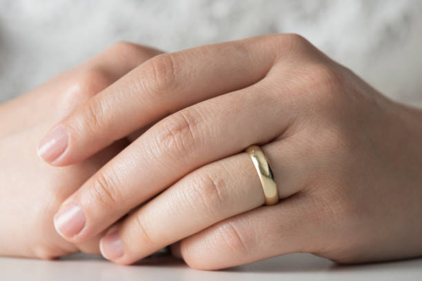 Woman Hands With Engagement Ring Woman and gold ring. gold ring on finger stock pictures, royalty-free photos & images