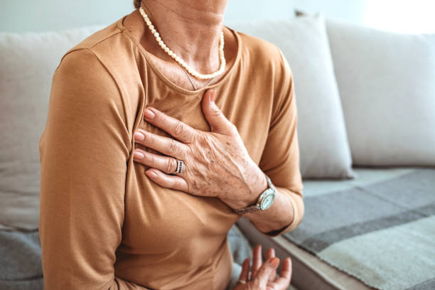 kvinna som har ont i hjärtområdet. - medelålders kvinna bröstsmärtor bildbanksfoton och bilder