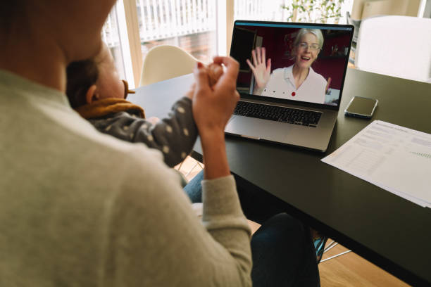 Woman having a video call with her mother Woman with her daughter having video call with her mother. Woman connecting with her mother on a video call while at home. south africa covid stock pictures, royalty-free photos & images