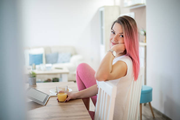 Woman having breakfast in pajamas Morning, Tablet, Domestic Kitchen, Human Hand, Kitchen. Home. Pajamas pink hair stock pictures, royalty-free photos & images