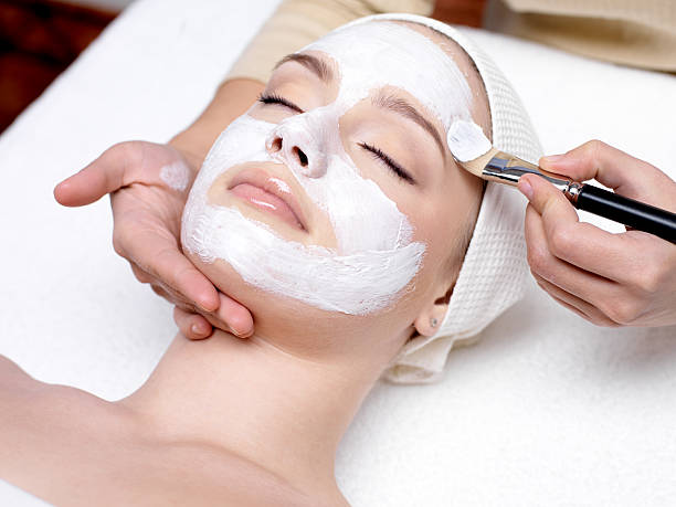 Woman having facial mask at beauty salon Beautiful young girl with facial mask at beauty salon spa treatment photos stock pictures, royalty-free photos & images